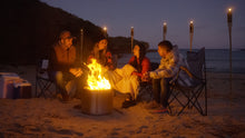 Load image into Gallery viewer, People gathering around the Ecoflame Smokeless fire pit on the beach
